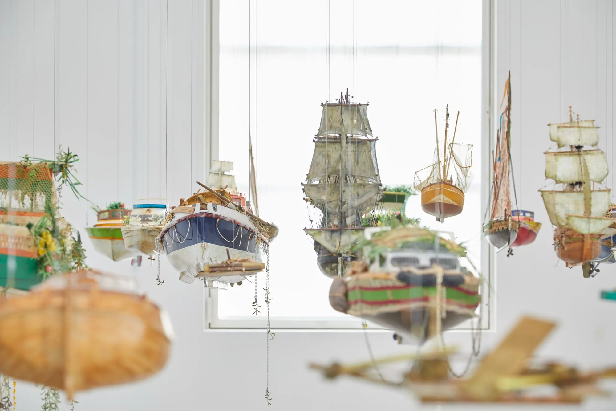 Photo of boat sculptures hanging in mid air