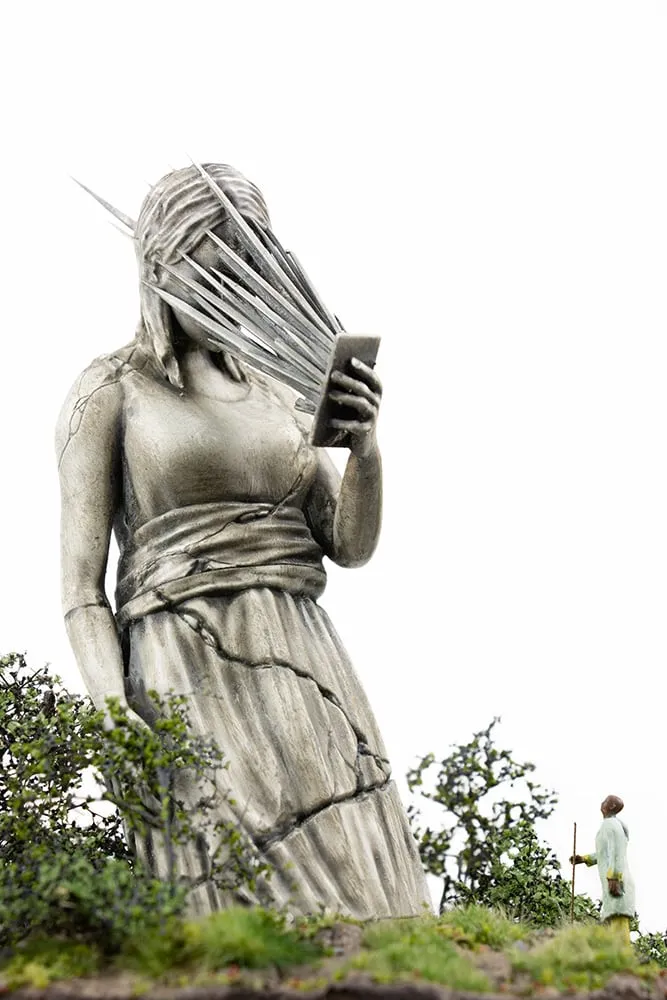 Sculpture of a woman with daggers coming out of her phone screen